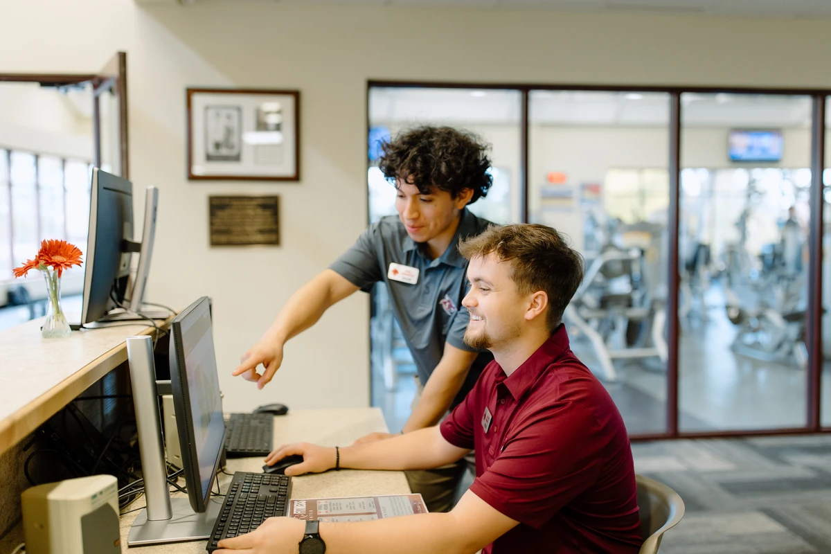 Two students working on a computer.